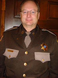 Lewis and Clark County Sheriff headshot in uniform with a wood background