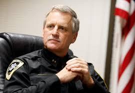 Yellowstone County Sheriff Mike Linder headshot with American Flag blurred in the background